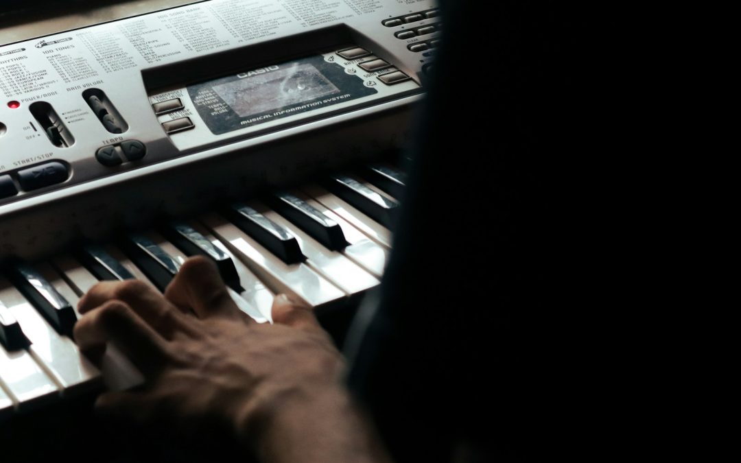 a person is playing a musical keyboard in the dark